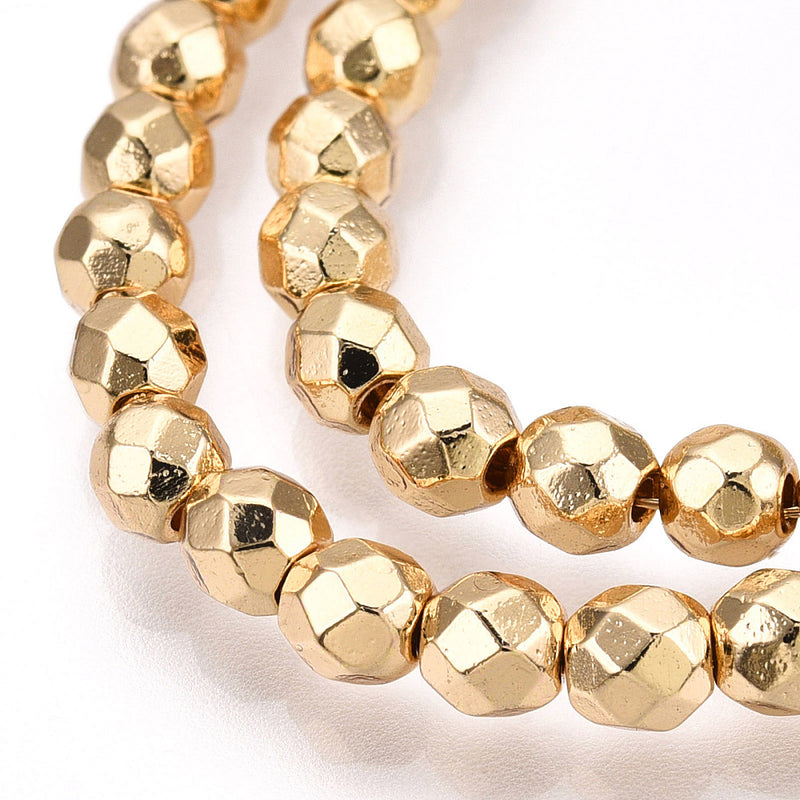 Hematit, syntetisk facetterad rund 4 mm, guld, 1 sträng (13900)